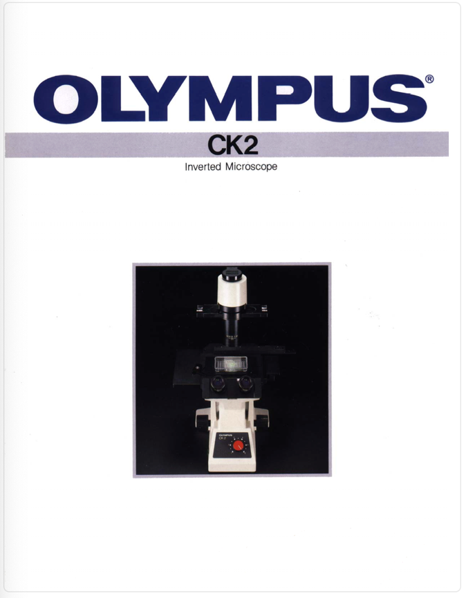 A white and black microscope
Description automatically generated