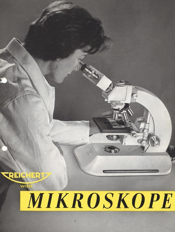 A person looking through a microscope
Description automatically generated