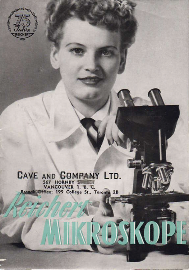 A person in a white coat holding a microscope
Description automatically generated