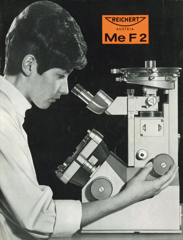 A person looking through a microscope
Description automatically generated