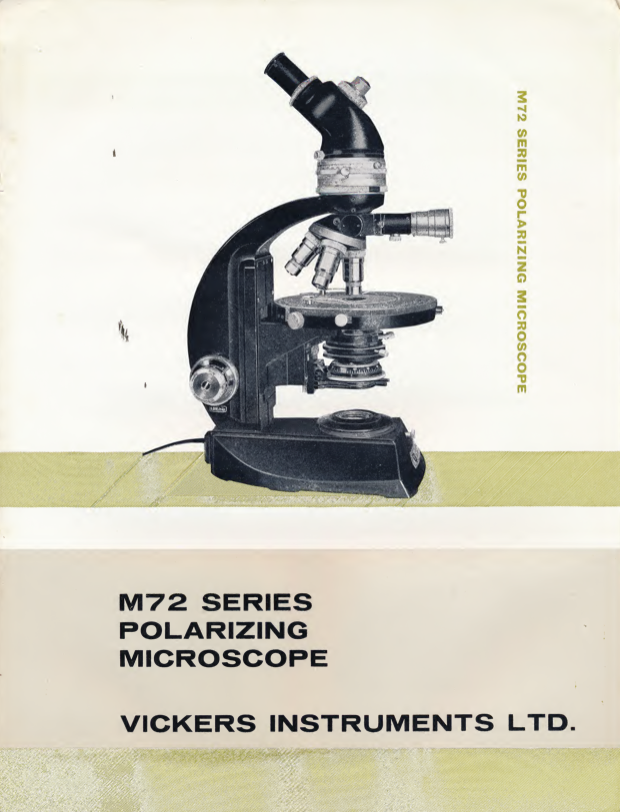 A black and white cover with a microscope
Description automatically generated