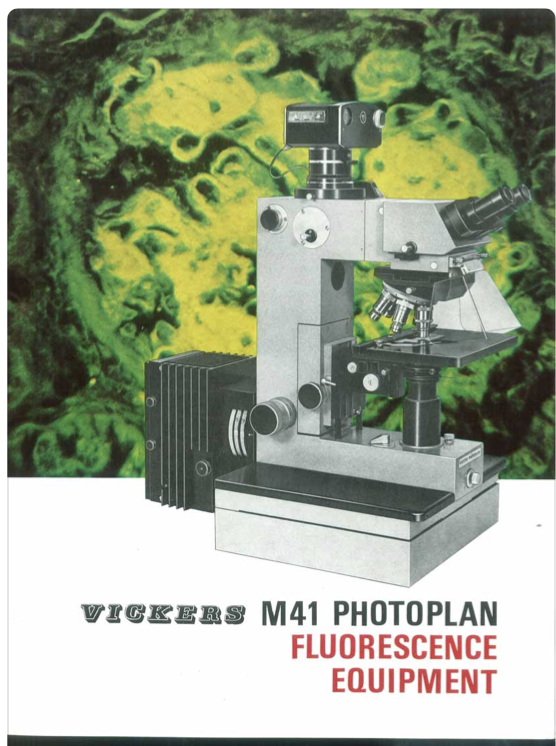 A microscope with a green background
Description automatically generated