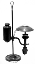 A picture containing lamp, cylinder, light fixture, indoor
Description automatically generated