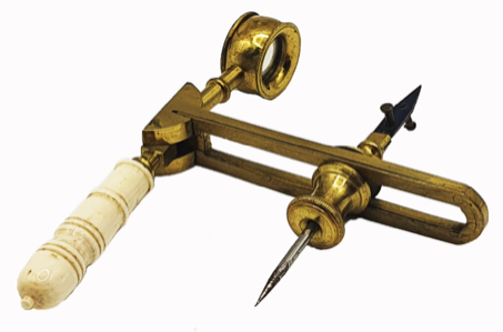 A brass and white object with a white handle
Description automatically generated