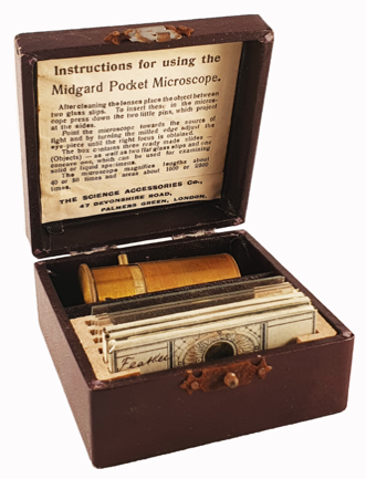 A box with a microscope and cards
Description automatically generated